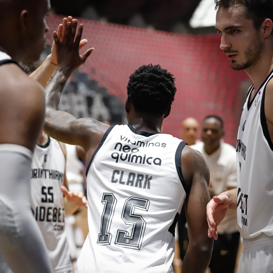 Elyjah Clark cumprimentando companheiros do basquete enquanto entra em quadra